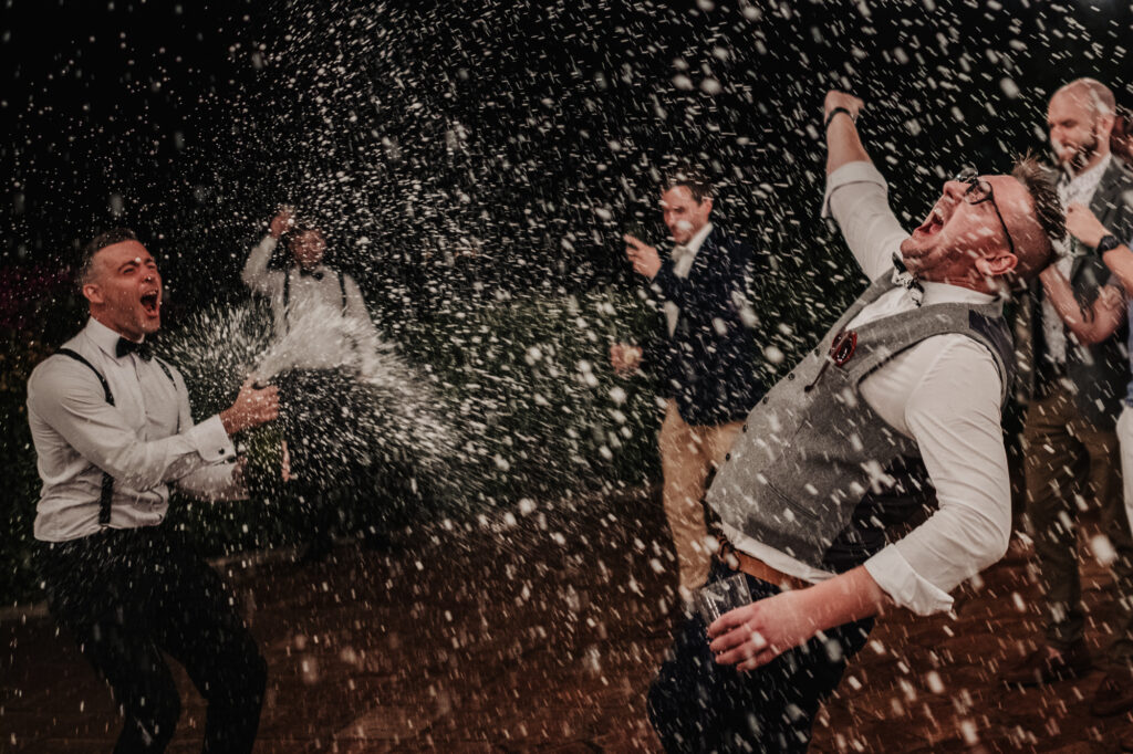 Wedding guests spraying champagne during the evening party at Almiral de la Font