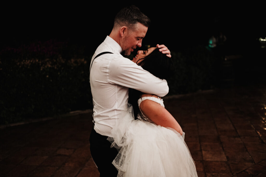 Bride and groom dancing together at night during their Almiral de la Font wedding
