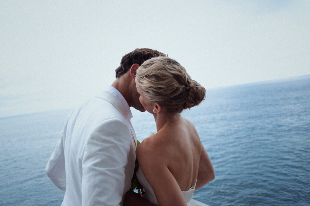 Couple standing by railing overlooking sea at El Convent Blanes wedding