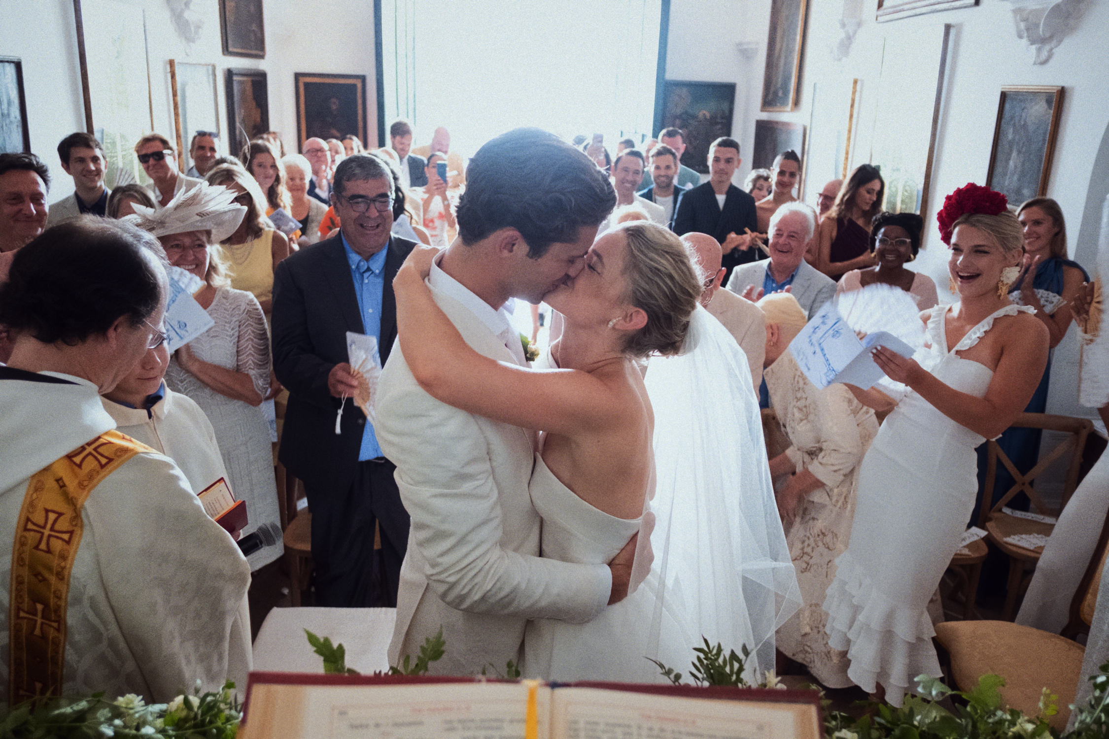 Chapel ceremony at El Convent Blanes wedding with guests standing close to the couple