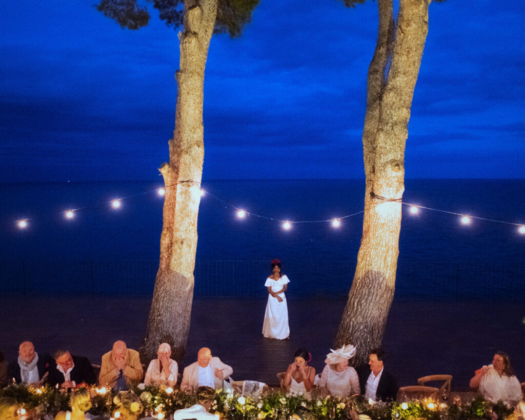 Evening dinner on terrace at El Convent Blanes with lights on