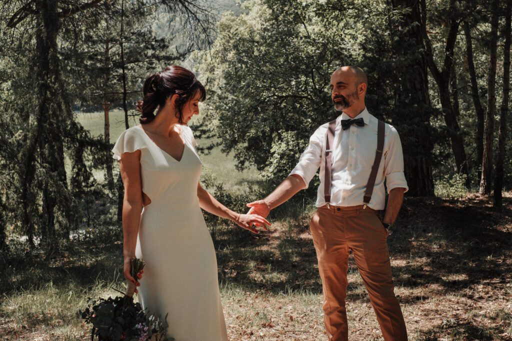 Bride and groom holding hands during their meadow session at El Dalmau