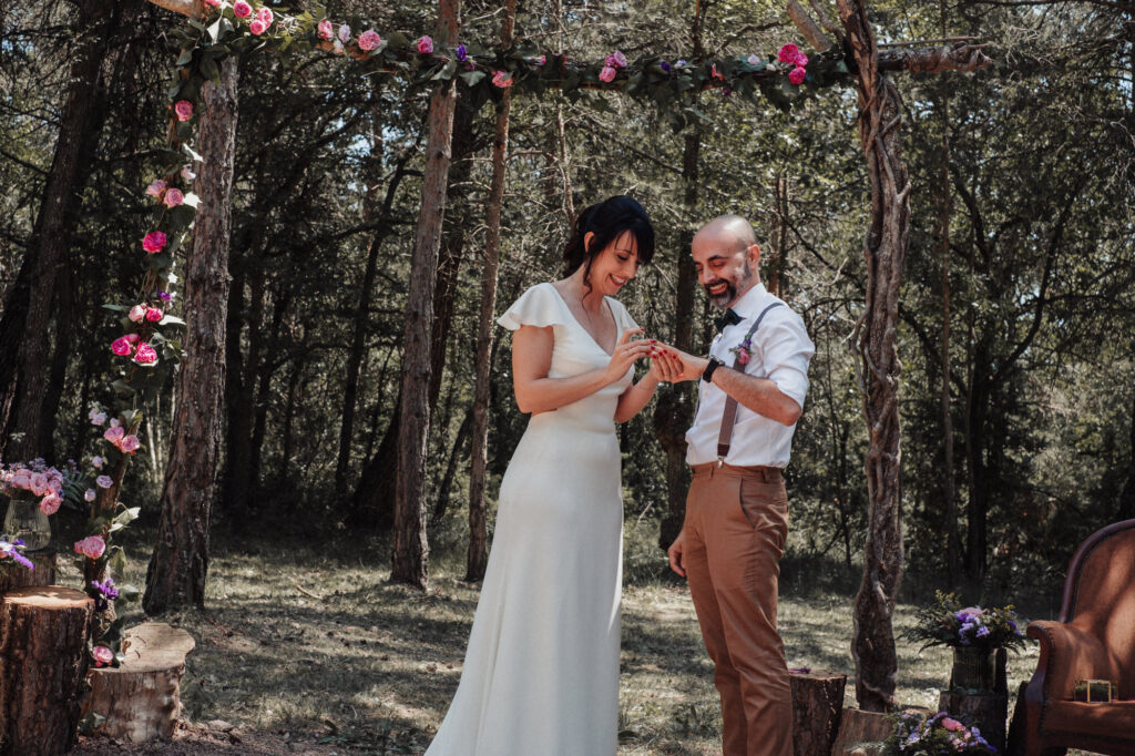 Bride and groom exchange rings at during their wedding ceremony at EL Dalmau