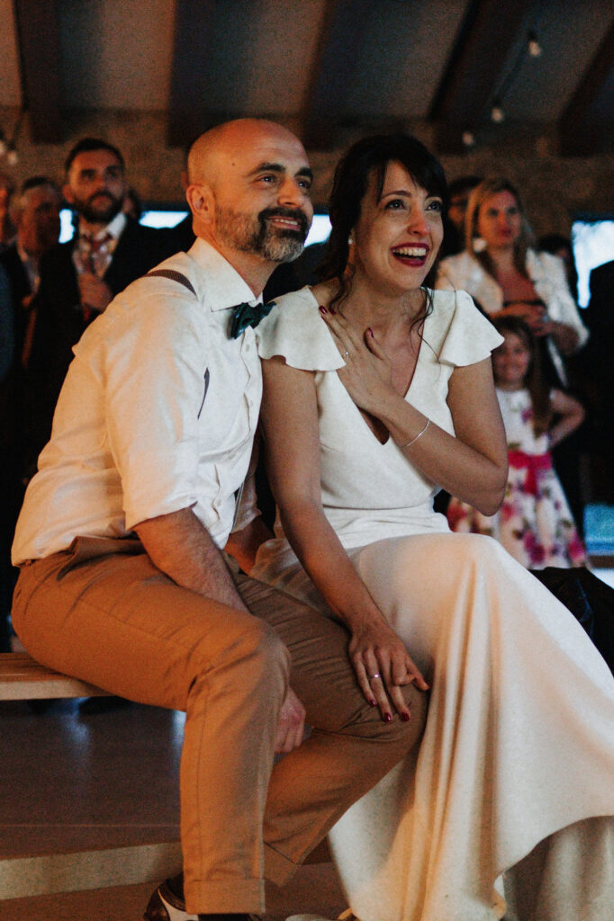 Bride and groom sitting together during the evening reception