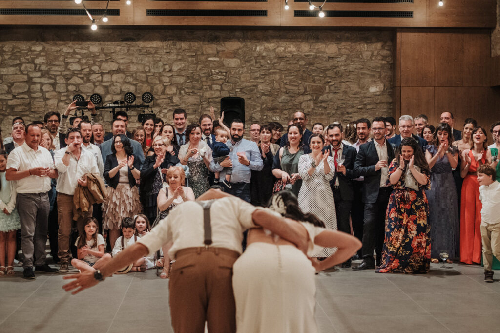 Bride and groom bowing to guests at the end of the party
