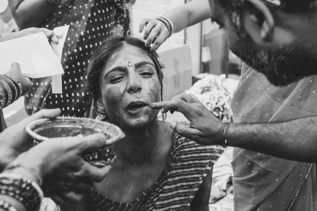 Black and white photograph of bride during the haldi ceremony at an Indian wedding in Hampshire