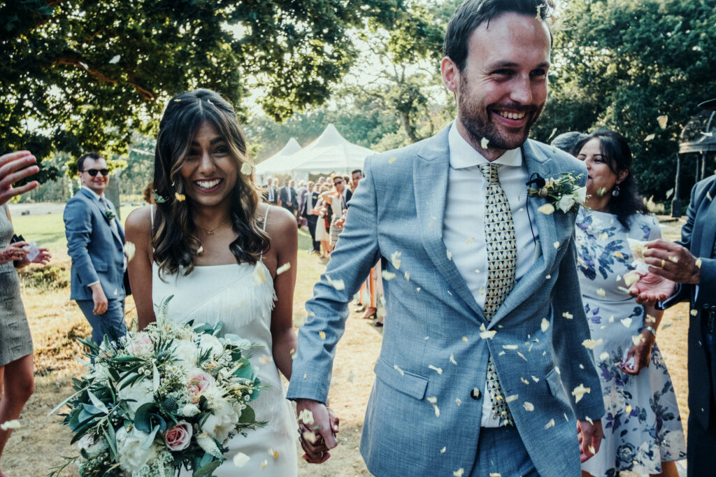 Bride and groom walking through guests after the ceremony