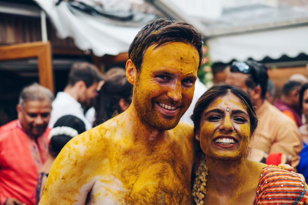 Bride and groom covered in turmeric after the haldi ceremony