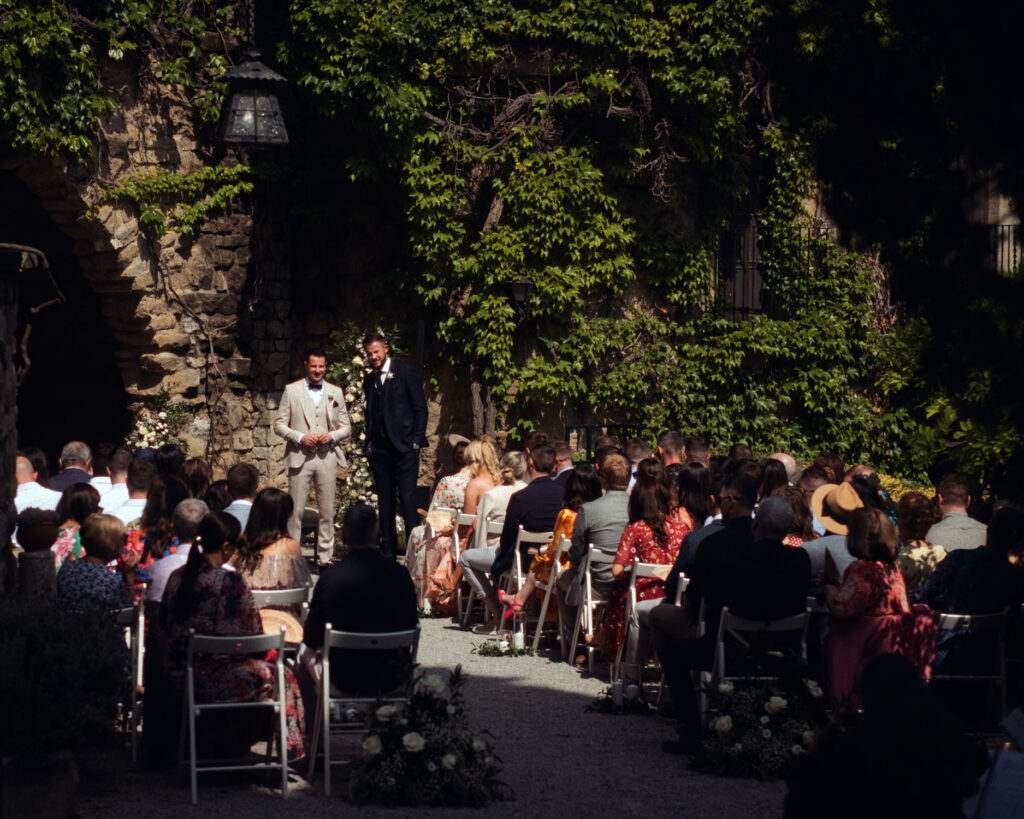 Outdoor ceremony at La Baronia Barcelona wedding venue with guests seated on both sides