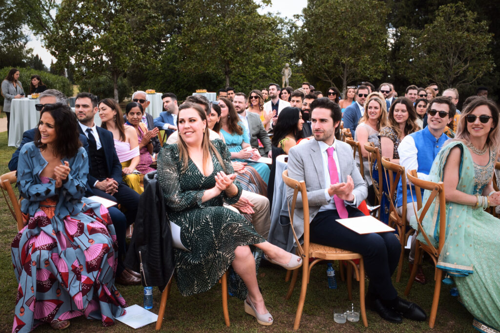 Guests seated during outdoor Indian wedding ceremony Barcelona