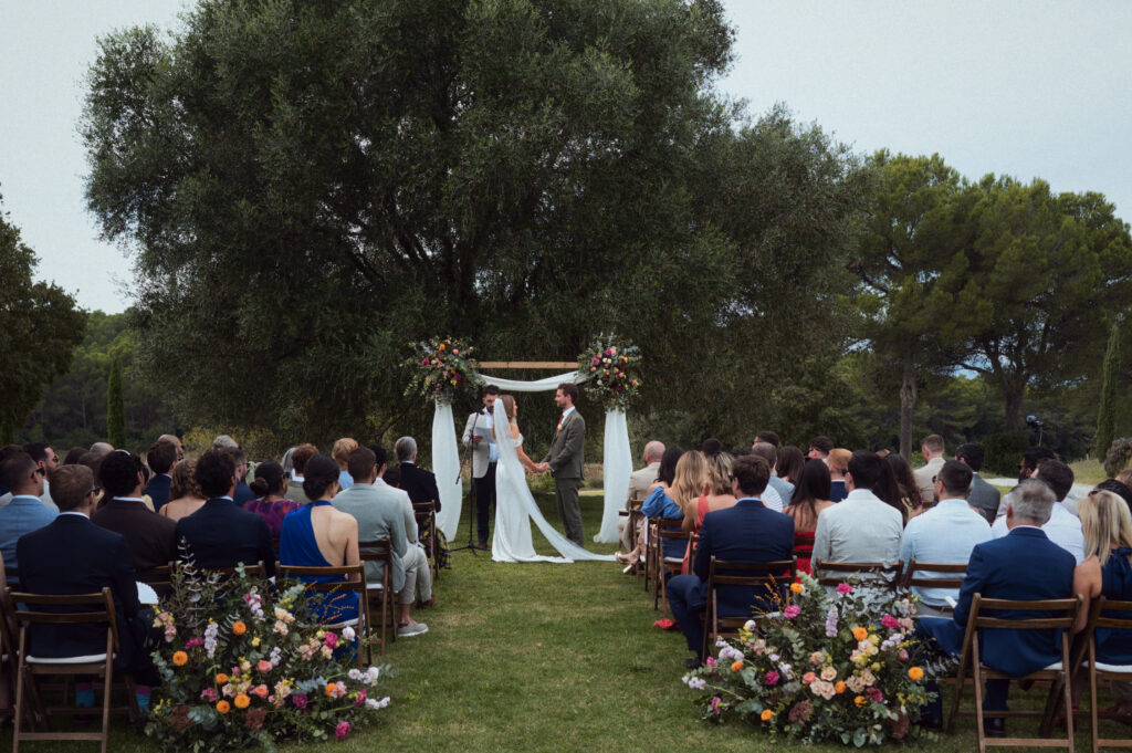 Outdoor wedding ceremony with guests seated