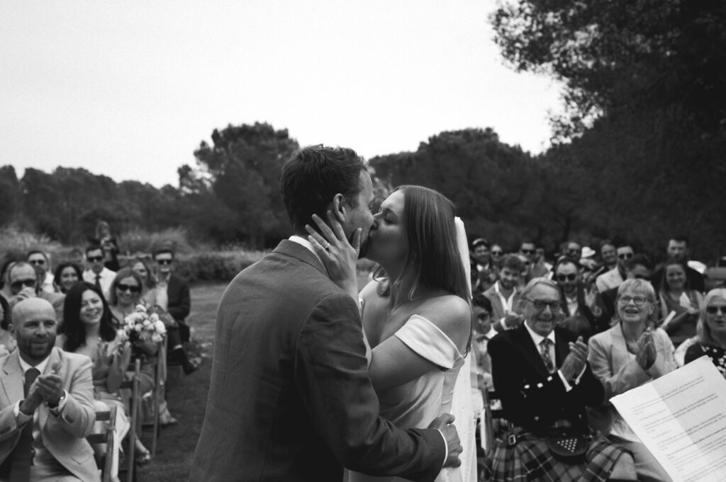 Outdoor ceremony bride ad groom kiss