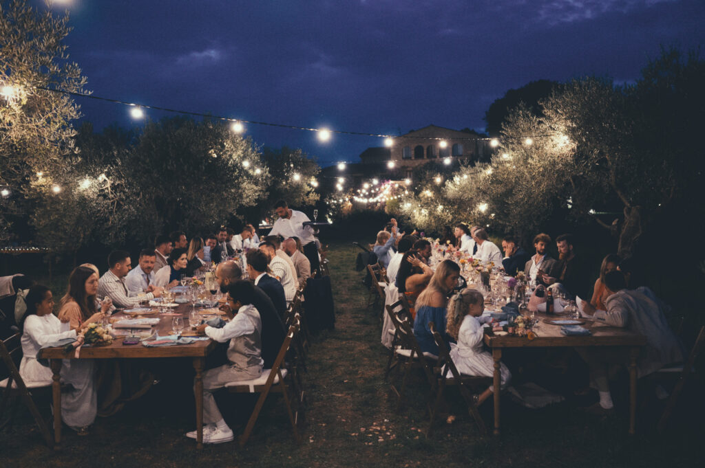 Dinner setup at Mas Terrats wedding with long tables and evening lights in the Catalan countryside